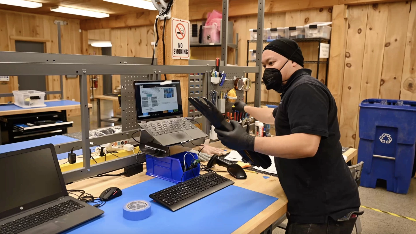 An operator performs an inspection of a prosthetic limb.